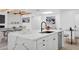 Open-concept kitchen with a large island, modern fixtures, and seamless flow to the dining and living areas at 5756 N 78Th Pl, Scottsdale, AZ 85250