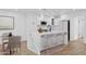 Bright kitchen features white cabinetry, stainless steel appliances, and a waterfall island with bar seating at 5756 N 78Th Pl, Scottsdale, AZ 85250
