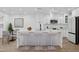 Modern kitchen featuring a large island with seating, sleek countertops, and stainless steel appliances at 5756 N 78Th Pl, Scottsdale, AZ 85250