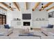 Spacious living room with beamed ceilings, a fireplace, built-in storage, and a comfortable seating area at 5756 N 78Th Pl, Scottsdale, AZ 85250