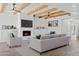 Bright and airy living room featuring beamed ceilings, a fireplace, built-in storage, and stylish decor at 5756 N 78Th Pl, Scottsdale, AZ 85250
