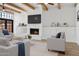Bright living room showcasing beamed ceilings, a fireplace, built-in cabinets, and modern furniture at 5756 N 78Th Pl, Scottsdale, AZ 85250