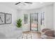 Bright living room featuring plantation shutters, ceiling fan, modern art, and neutral furniture at 5756 N 78Th Pl, Scottsdale, AZ 85250