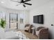 Bright living room featuring plantation shutters, neutral furniture, and a mounted television at 5756 N 78Th Pl, Scottsdale, AZ 85250