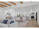 Bright living space with an open layout, connecting the living room, dining area, and kitchen, all with beamed ceilings at 5756 N 78Th Pl, Scottsdale, AZ 85250