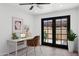 Bright home office with black framed doors leading to a private patio at 5756 N 78Th Pl, Scottsdale, AZ 85250