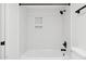 A bright white shower and tub combination with neutral fixtures and a sleek, modern design at 5756 N 78Th Pl, Scottsdale, AZ 85250