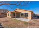 A view of the backyard featuring a covered patio and brick wall at 8009 S 53Rd Ave, Laveen, AZ 85339