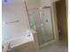 Relaxing bathroom with a separate soaking tub and glass-enclosed shower at 8009 S 53Rd Ave, Laveen, AZ 85339