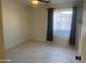 Comfortable bedroom featuring modern light fixture and tile floors at 8009 S 53Rd Ave, Laveen, AZ 85339