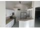 Bright kitchen with white cabinetry, stainless steel appliances, and a breakfast bar at 8009 S 53Rd Ave, Laveen, AZ 85339