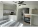 Spacious living room featuring an open floor plan, fireplace, white walls, and tile floors at 8009 S 53Rd Ave, Laveen, AZ 85339