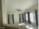 Open concept living room with neutral walls, ample natural light, and modern ceiling fan at 8009 S 53Rd Ave, Laveen, AZ 85339
