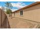 Backyard featuring a stucco house with multiple windows and gravel landscaping for low maintenance at 10317 E Kiva Cir, Mesa, AZ 85209