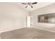 A carpeted bedroom featuring a ceiling fan and a window at 10317 E Kiva Cir, Mesa, AZ 85209
