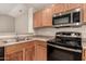 A kitchen featuring stainless steel appliances, light brown cabinets, and a stainless steel sink at 10317 E Kiva Cir, Mesa, AZ 85209