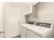 The laundry room includes a side-by-side washer and dryer and a door to the outside at 10317 E Kiva Cir, Mesa, AZ 85209