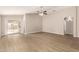 Spacious living room with light wood floors, neutral walls, and a ceiling fan at 10317 E Kiva Cir, Mesa, AZ 85209
