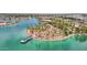 Aerial view of an island on a lake featuring lush landscaping, walking paths, and a dock at 10502 W Hutton Dr, Sun City, AZ 85351