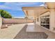Covered patio with a landscaped backyard featuring gravel, brick borders, and block fence at 10502 W Hutton Dr, Sun City, AZ 85351