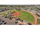 Aerial view of a well-maintained baseball field surrounded by residential homes and a parking lot at 10502 W Hutton Dr, Sun City, AZ 85351
