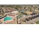 Aerial view of a community pool, tennis and shuffleboard courts, miniature golf, and parking at 10502 W Hutton Dr, Sun City, AZ 85351