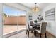 Cozy dining area with modern decor, a round table and a sliding glass door to patio at 10502 W Hutton Dr, Sun City, AZ 85351