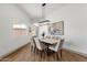 Elegant dining area with wood floors, modern lighting and comfortable seating at 10502 W Hutton Dr, Sun City, AZ 85351