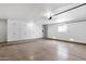 Spacious garage with bright lighting, built-in storage cabinets, and epoxy floors at 10502 W Hutton Dr, Sun City, AZ 85351