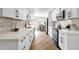 Modern kitchen with white cabinets, stainless steel appliances, and a dining area view at 10502 W Hutton Dr, Sun City, AZ 85351