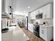 Bright kitchen featuring white cabinets, stainless steel appliances, and modern countertops at 10502 W Hutton Dr, Sun City, AZ 85351