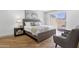 Comfortable bedroom with wood floors, nightstands, and patio access offering lots of natural light at 10502 W Hutton Dr, Sun City, AZ 85351