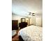 Comfortable bedroom featuring wood floors, dresser, and a view into the bathroom at 10852 N 39Th Ave, Phoenix, AZ 85029