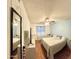 Bedroom with wood floors, blue accent wall, ceiling fan, and large window providing lots of natural light at 10852 N 39Th Ave, Phoenix, AZ 85029