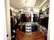 Walk-in closet with circular racks, shelving, and a light, providing ample storage space at 10852 N 39Th Ave, Phoenix, AZ 85029