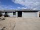 Charming single-story home with gray paint, low-maintenance landscaping, and an attached two-car garage at 10852 N 39Th Ave, Phoenix, AZ 85029