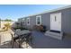 Charming backyard features a patio, artificial grass, desert landscaping, and a dining set at 10951 N 91St Ave # 6, Peoria, AZ 85345