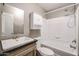 Bathroom features a shower-tub combo, vanity with a modern faucet, and white storage cabinet at 10951 N 91St Ave # 6, Peoria, AZ 85345