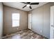 Comfortable bedroom featuring a window providing ample natural light and a cooling ceiling fan at 10951 N 91St Ave # 6, Peoria, AZ 85345