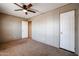 Spacious bedroom featuring a ceiling fan and closet doors, ideal for a comfortable retreat at 10951 N 91St Ave # 6, Peoria, AZ 85345