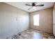 Bright bedroom with natural light, wood-look flooring, and ceiling fan enhancing comfort at 10951 N 91St Ave # 6, Peoria, AZ 85345