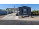 Exterior of home featuring covered parking, landscaped yard, and gray siding at 10951 N 91St Ave # 6, Peoria, AZ 85345