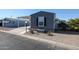 Exterior of home featuring covered parking, landscaped yard, and gray siding at 10951 N 91St Ave # 6, Peoria, AZ 85345