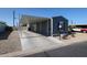 Exterior of home featuring covered parking, landscaped yard, and gray siding at 10951 N 91St Ave # 6, Peoria, AZ 85345