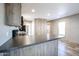 Kitchen featuring wood cabinets, black appliances, and breakfast bar at 10951 N 91St Ave # 6, Peoria, AZ 85345