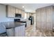 Kitchen featuring wood cabinets, black appliances, and breakfast bar at 10951 N 91St Ave # 6, Peoria, AZ 85345