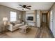 Inviting living room with a ceiling fan, comfortable seating, and an entertainment center with a mounted television at 10951 N 91St Ave # 6, Peoria, AZ 85345