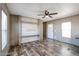 Living room featuring vinyl floors and custom entertainment center at 10951 N 91St Ave # 6, Peoria, AZ 85345