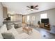 Open living space with wood-look flooring, a ceiling fan, a comfortable sofa, and a dining area at 10951 N 91St Ave # 6, Peoria, AZ 85345