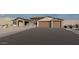 This beautiful home features a stone facade, large windows, and a spacious three-car garage at 11648 S Airport Rd, Buckeye, AZ 85326